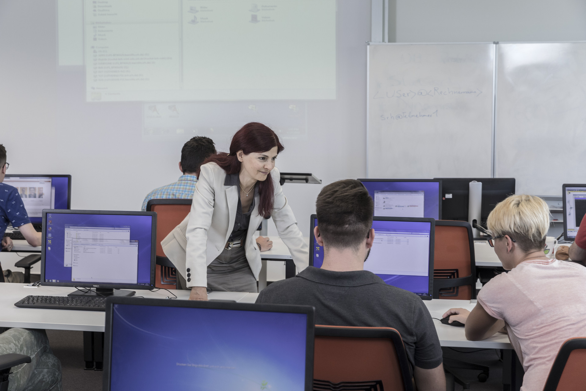 IT-Dozentin erklärt Teilnehmenden etwas IT-Dozentin in der Klasse